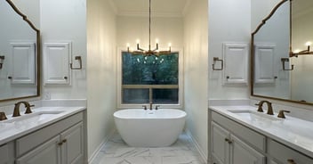 Luxurious bathroom remodel in San Antonio by Wade Caldwell featuring double sinks, freestanding tub, and elegant gold fixtures