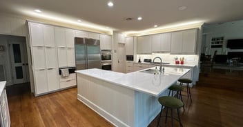 Modern San Antonio kitchen remodel with white cabinets, marble countertops, stainless steel appliances, and spacious island