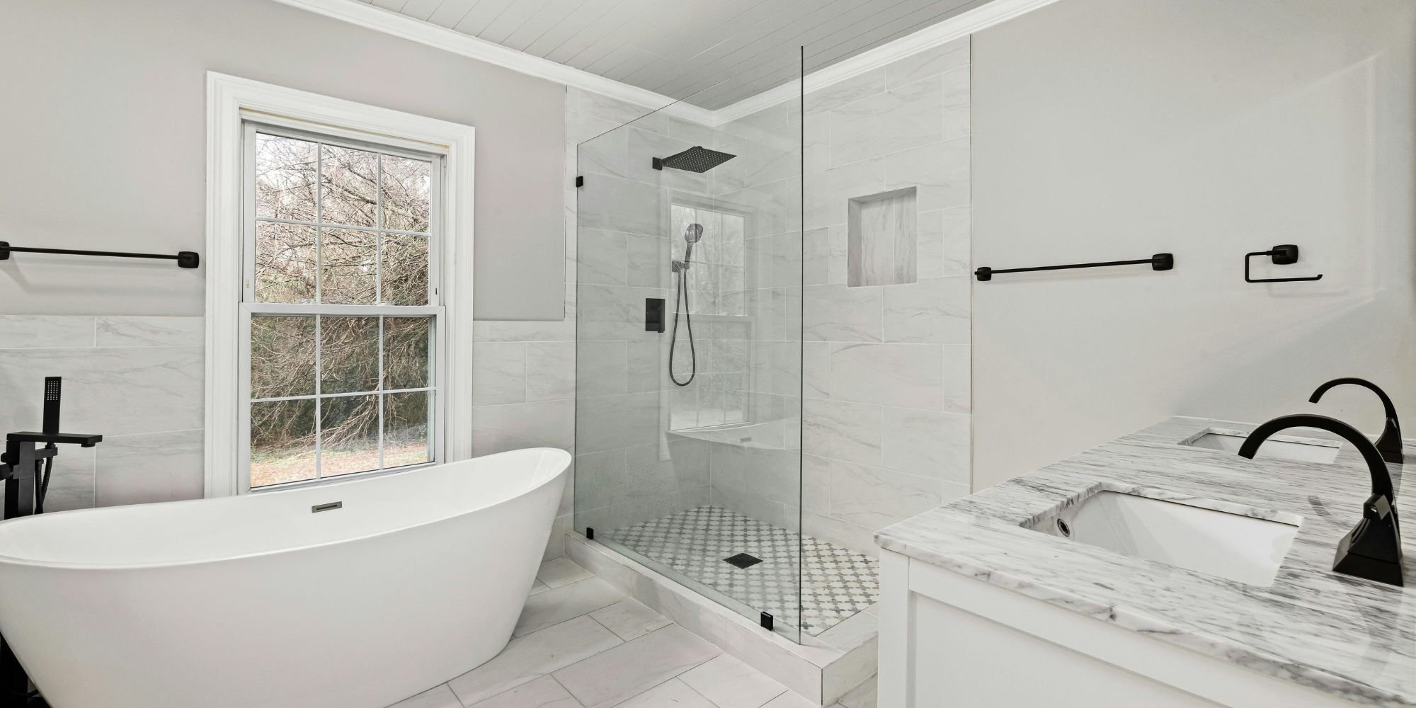 Contemporary bathroom remodel with freestanding tub and glass shower by Wade Caldwell in San Antonio