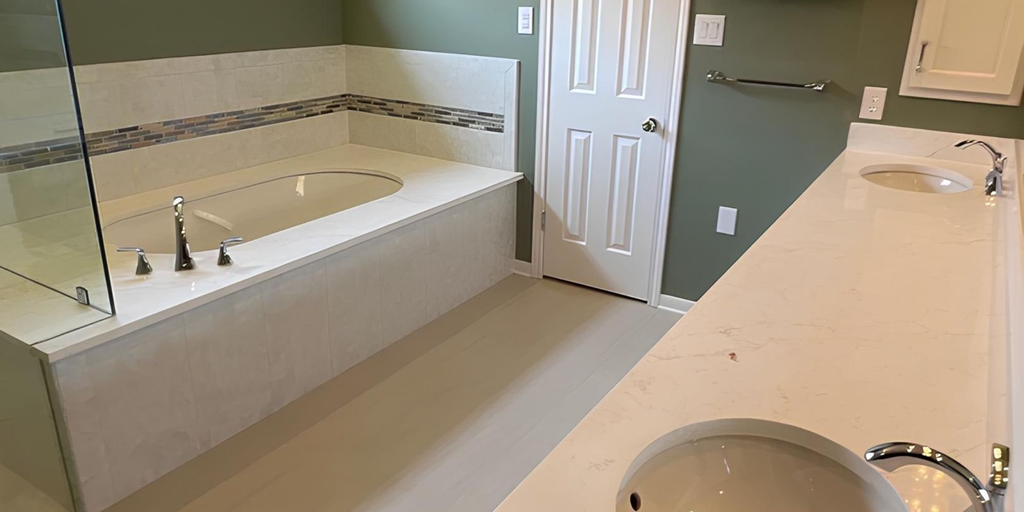 Elegant bathroom upgrade with glass-enclosed tub area and dual sinks by Wade Caldwell in San Antonio.