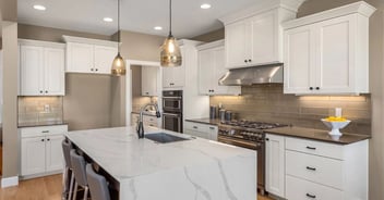 San Antonio kitchen remodel by Wade Caldwell Construction with white shaker cabinets and marble island
