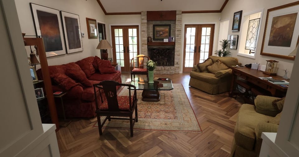 Cozy living room remodel in San Antonio with herringbone wood floors and French doors by Wade Caldwell Construction