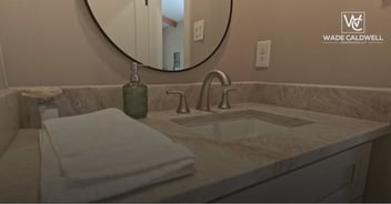 Custom bathroom remodel by Wade Caldwell Construction featuring stone countertop