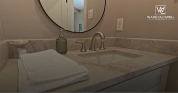 Custom bathroom remodel by Wade Caldwell Construction featuring stone countertop
