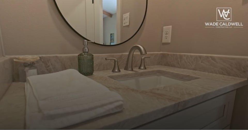 Custom bathroom remodel by Wade Caldwell Construction featuring stone countertop in San Antonio