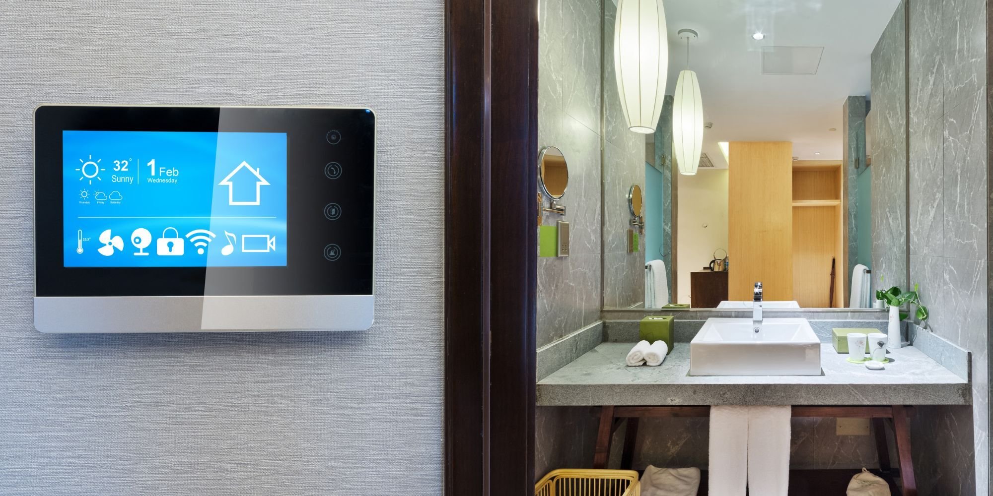 Modern San Antonio bathroom remodel by Wade Caldwell featuring wall-mounted smart home control panel and sleek gray mar