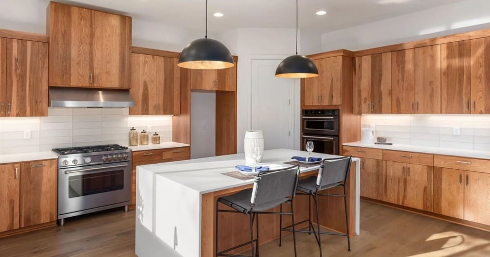 San Antonio kitchen remodel showcasing warm wood cabinets, quartz countertops, and island seating by Wade Caldwell Construction-1