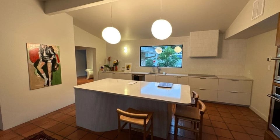 Contemporary kitchen remodel in San Antonio by Wade Caldwell Construction featuring minimalist white cabinetry and l