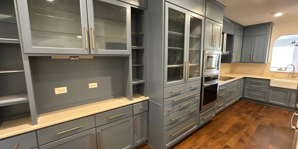 Custom blue cabinetry and hardwood floors in a San Antonio kitchen remodel by Wade Caldwell Construction