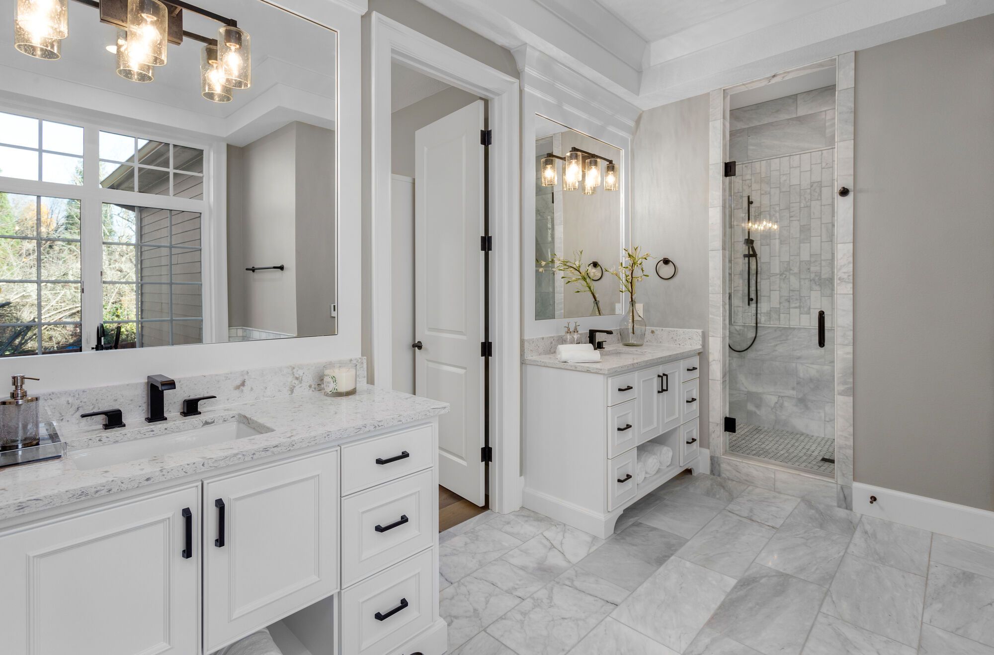 Classic white bathroom renovation with black fixtures and stone finishes by Wade Caldwell Construction in Terrell Hills, TX