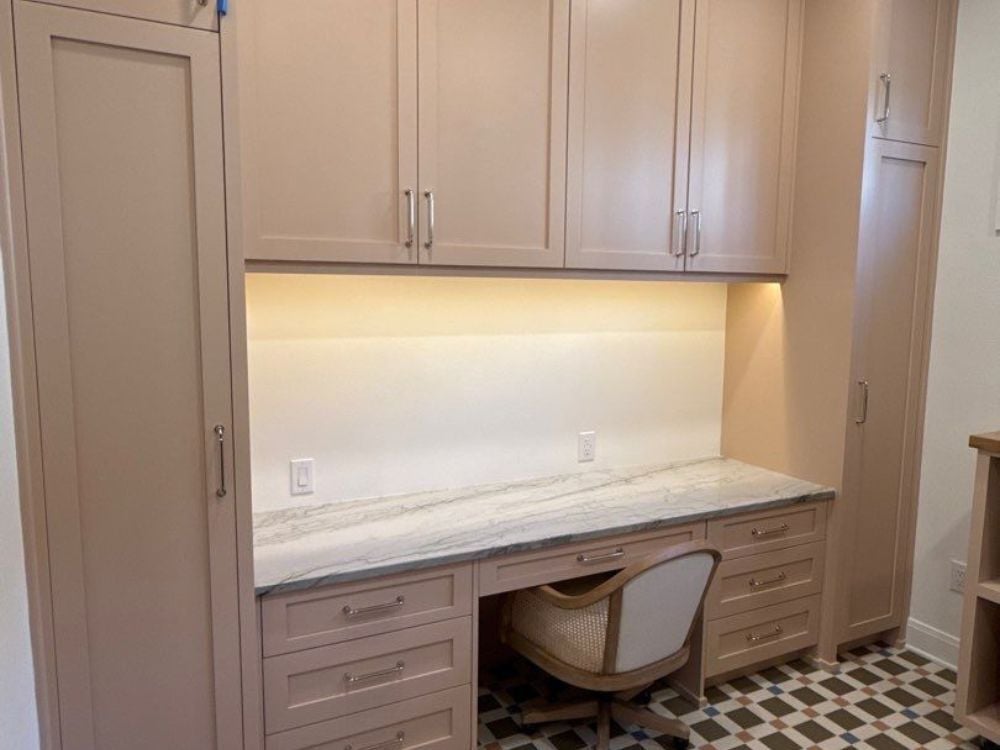 Laundry room with built-in desk and cabinets by Wade Caldwell Construction in Alamo Heights, TX