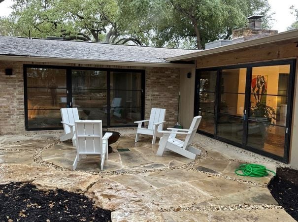 Stone patio with white Adirondack chairs from whole house remodel by Wade Caldwell Construction Stone patio with white Adirondack chairs from whole house remodel by Wade Caldwell Construction