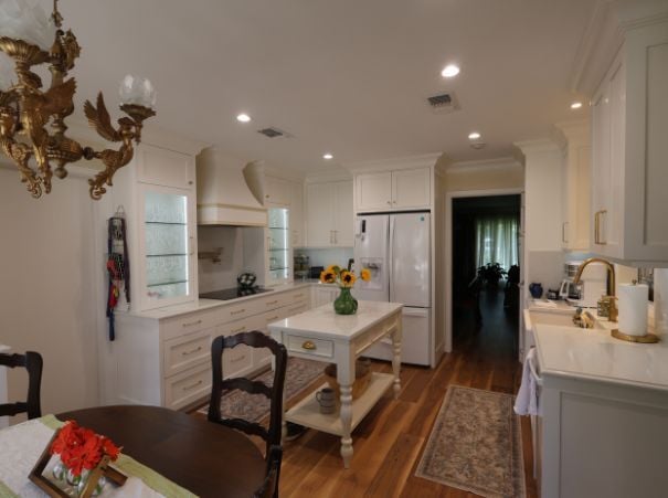 Traditional kitchen remodel with white cabinetry and wood floors by Wade Caldwell Construction