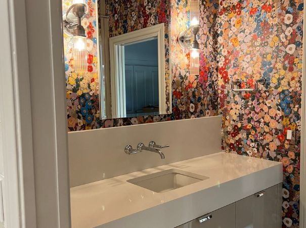 Wade Caldwell Construction bathroom renovation featuring vibrant wall design and sleek white countertop