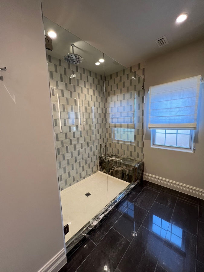 Frameless glass shower with modern tile in San Antonio bathroom remodel by Wade Caldwell