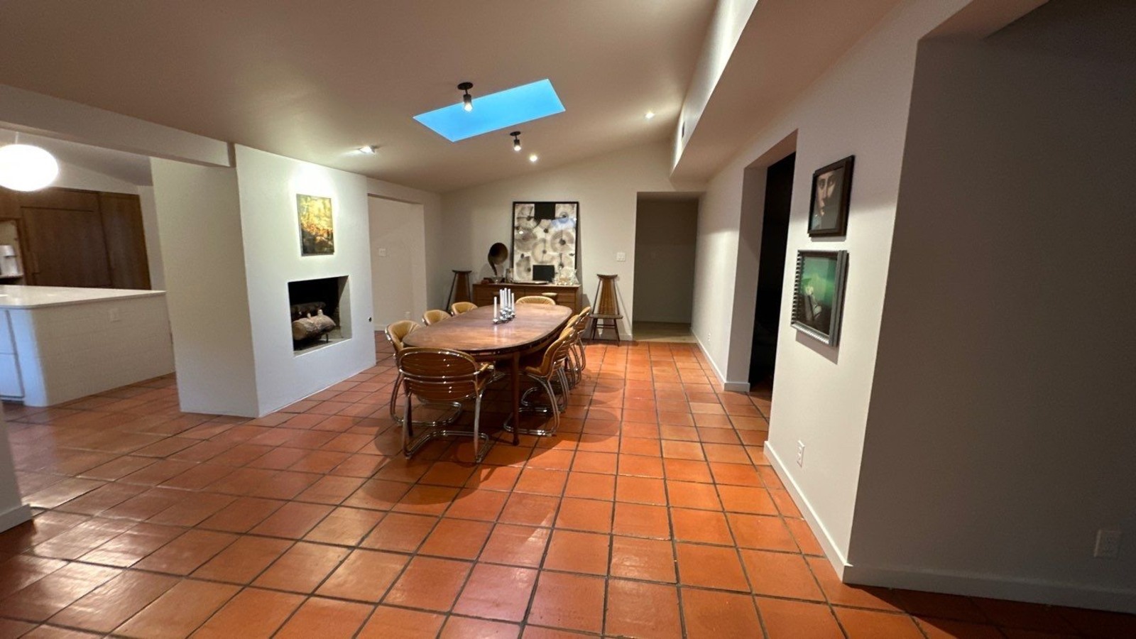 Whole home renovation featuring mid-century dining space and warm tile floors in Shava