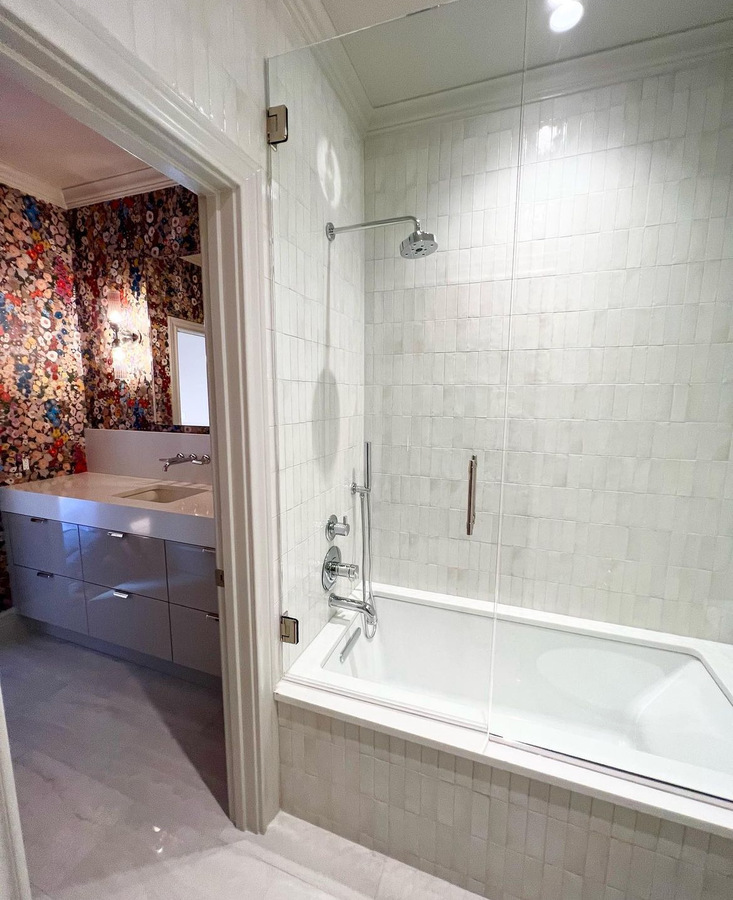 Elegant tub-shower combo with glass door in Alamo Heights remodel by Wade Caldwell Construction
