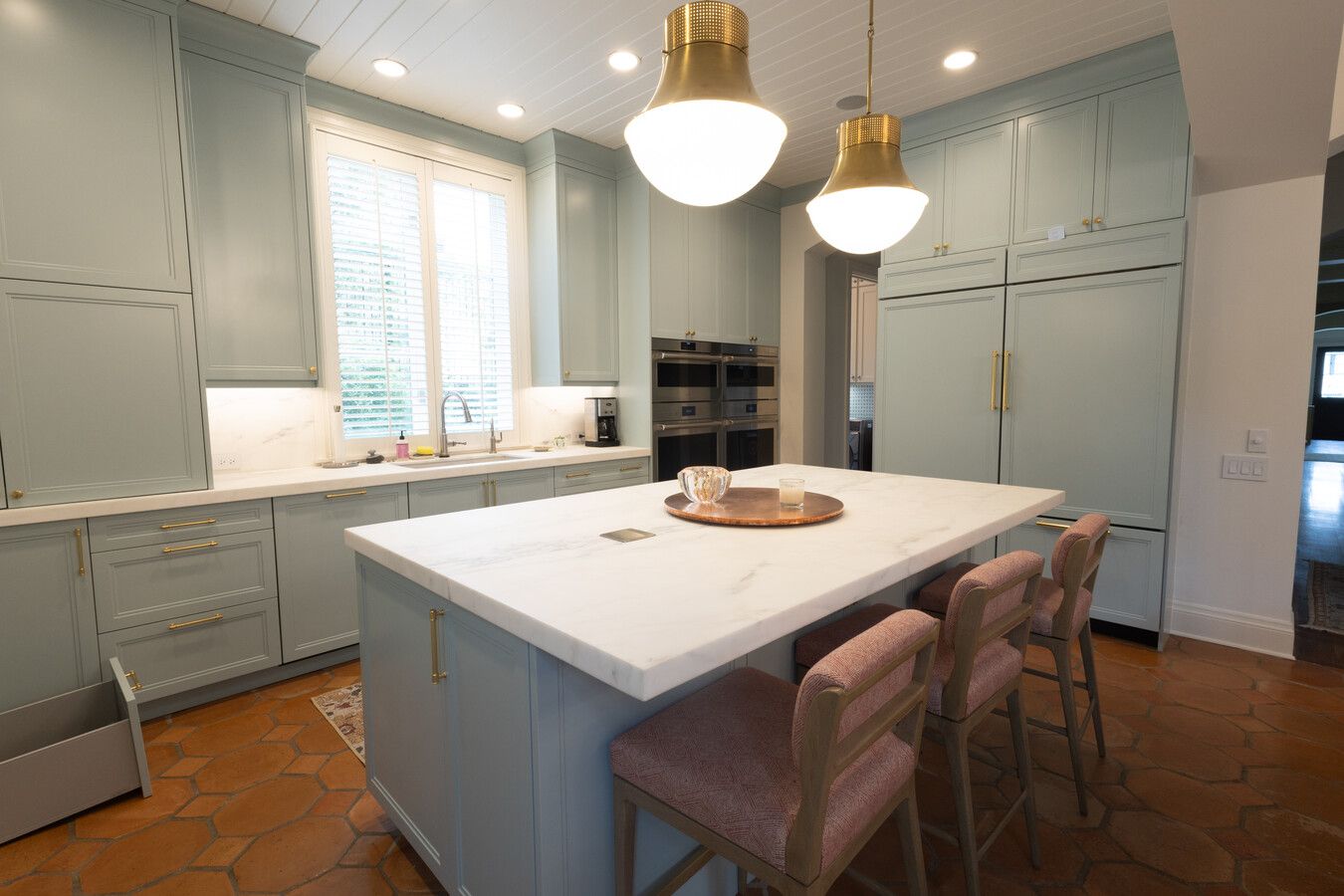 Wade Caldwell Construction completed a custom kitchen renovation in Olmos Park, TX with modern pendant lighting and terracotta floors