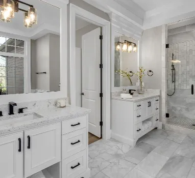 Classic white bathroom renovation with black fixtures and stone finishes by Wade Caldwell Construction in Terrell Hills, TX